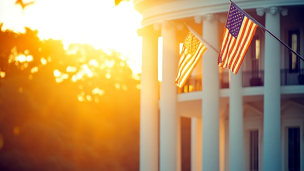 Flags hang above a stone government building as dusk settles over the square.