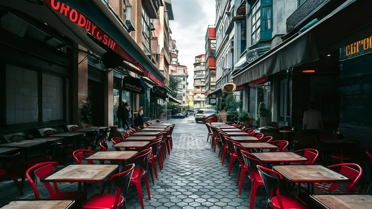 An outdoor cafe fills an Istanbul side street on a bright and quiet morning.