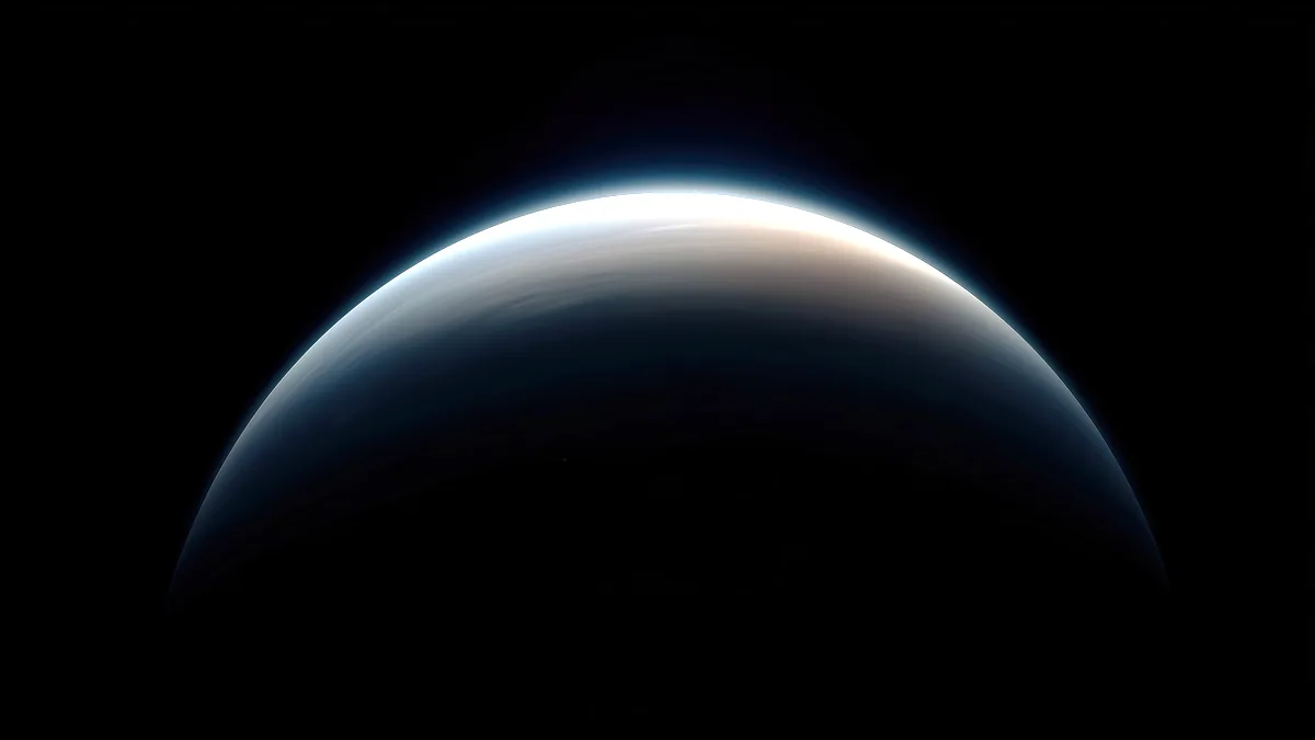 The curved limb of Earth glows blue against the black of space.